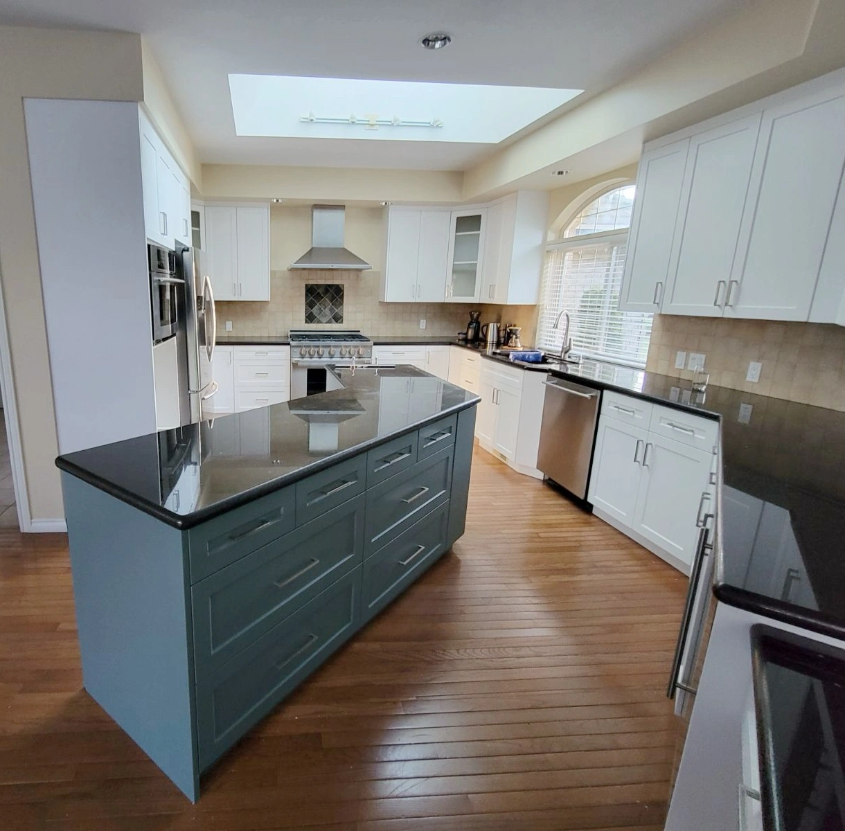 Calgary kitchen restyling with white cabinets, green island, updated countertops, and refreshed finishes