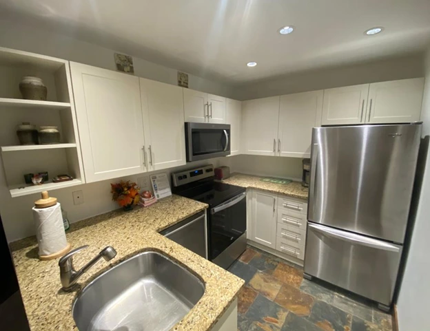 Kitchen with freshly painted cabinets and updated hardware in a budget-friendly renovation