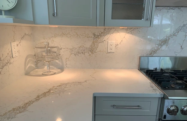 Small kitchen remodel in Vancouver with quartz countertop backsplash, light grey refaced cabinets and undermount lighting by 180 Kitchens